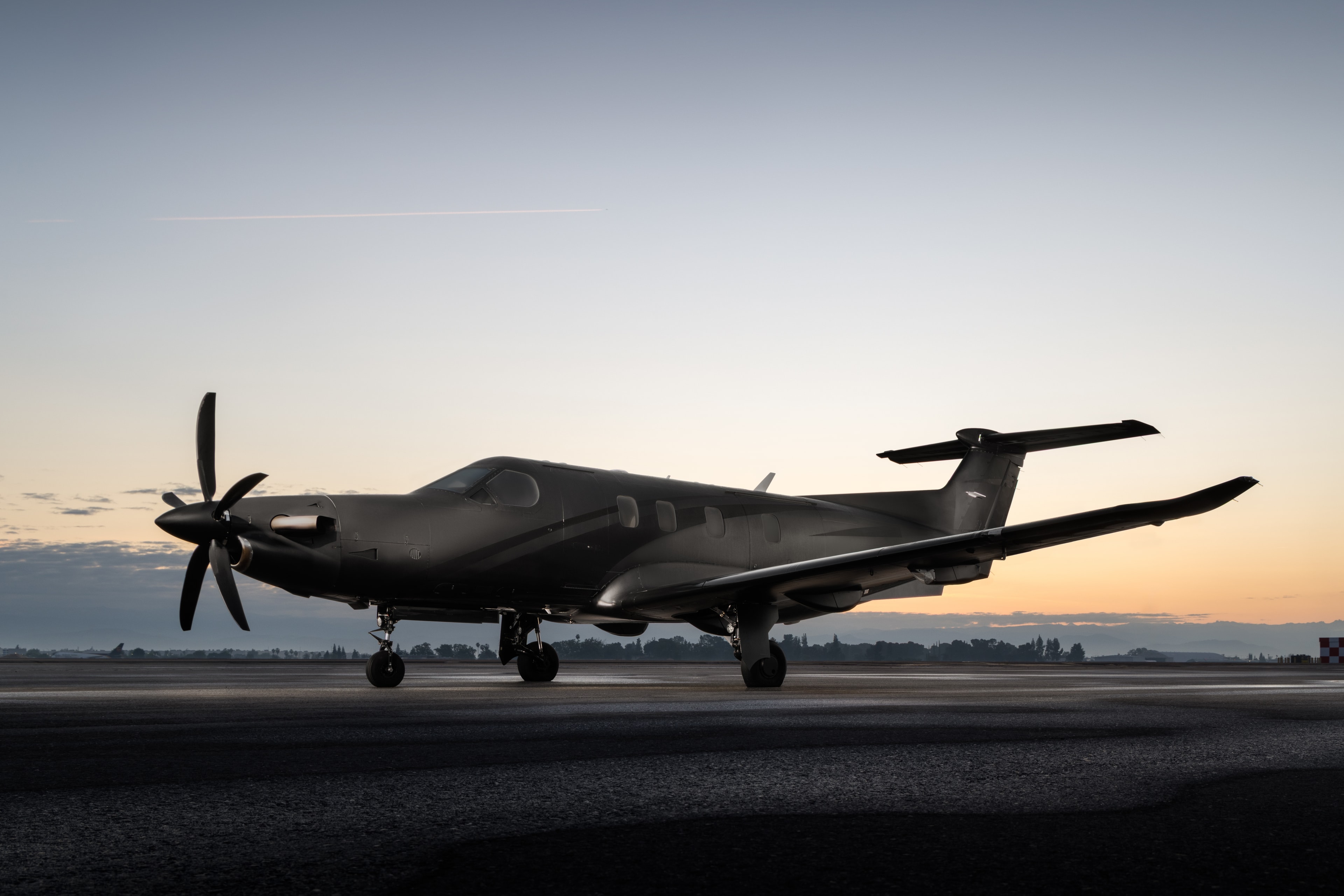 Black turboprop aircraft on runway